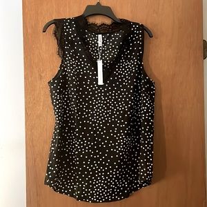 Black and white polka dot poly blend tank top. Never worn with tags. Size Large